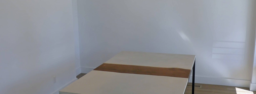 walnut, concrete, and steel dining table