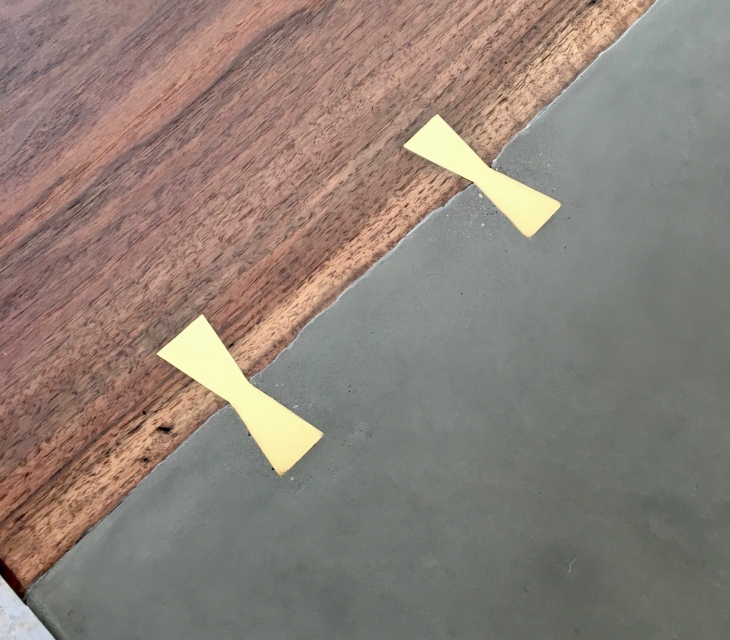Concrete and walnut dining table