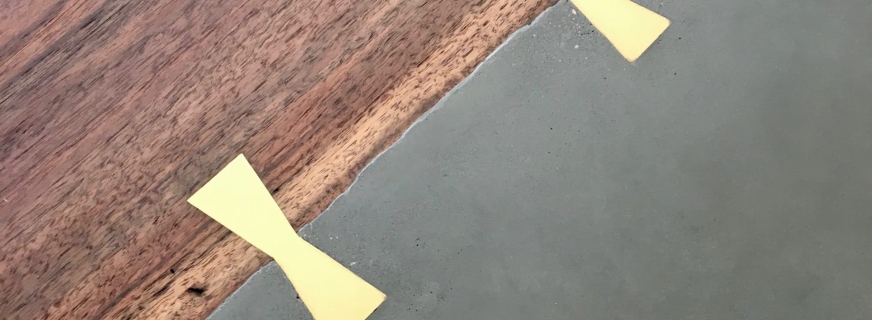 Concrete and walnut dining table