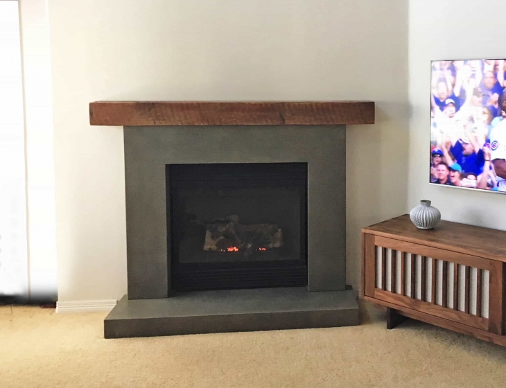 Reclaimed wood and concrete fireplace surround